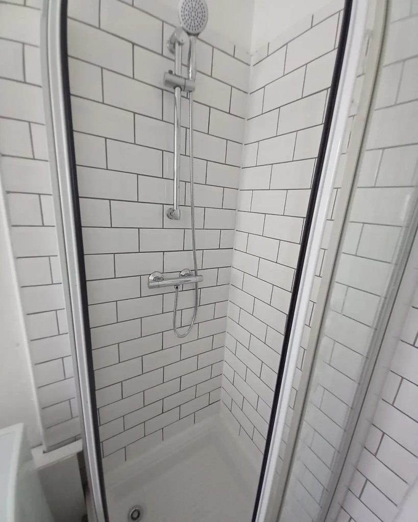 Photo of small shower area with tiling, shower and shower screen installed by Builder Base in Newport, South Wales