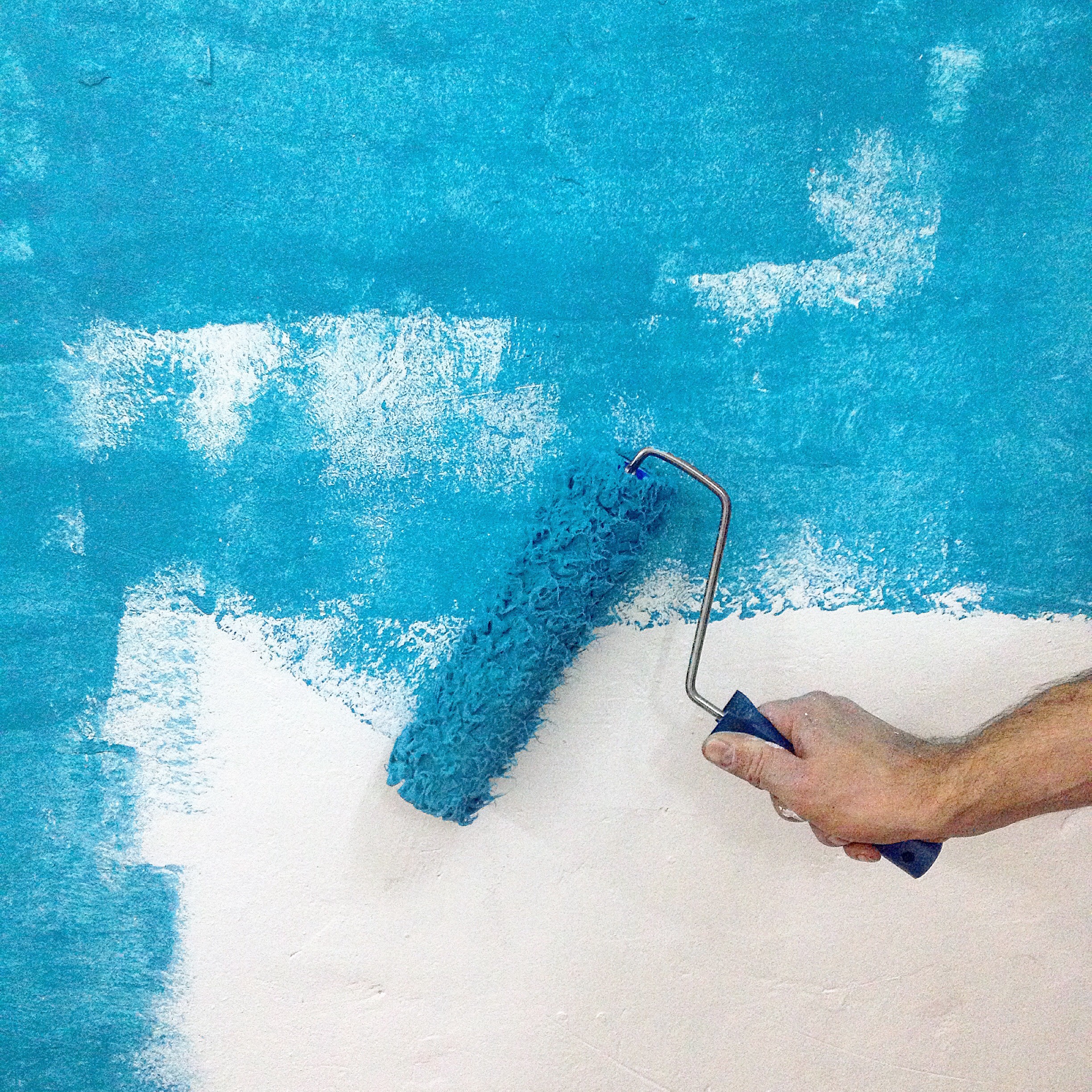 A person painting white wall blue by Builder Base in Newport, South Wales